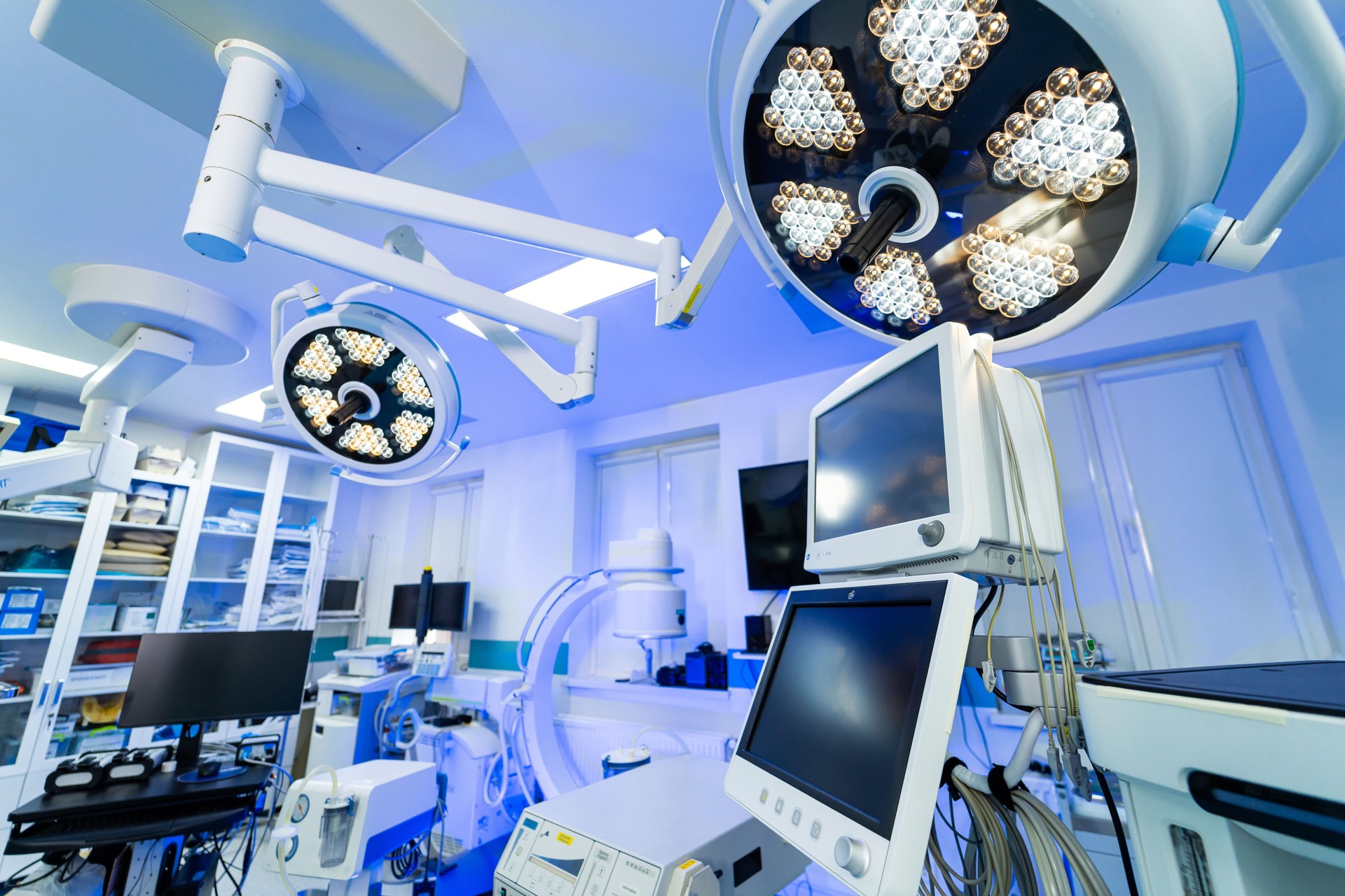 Neurosurgery OR setup. Advanced neurosurgery operating room equipped with modern surgical lights and medical equipment for patient care.