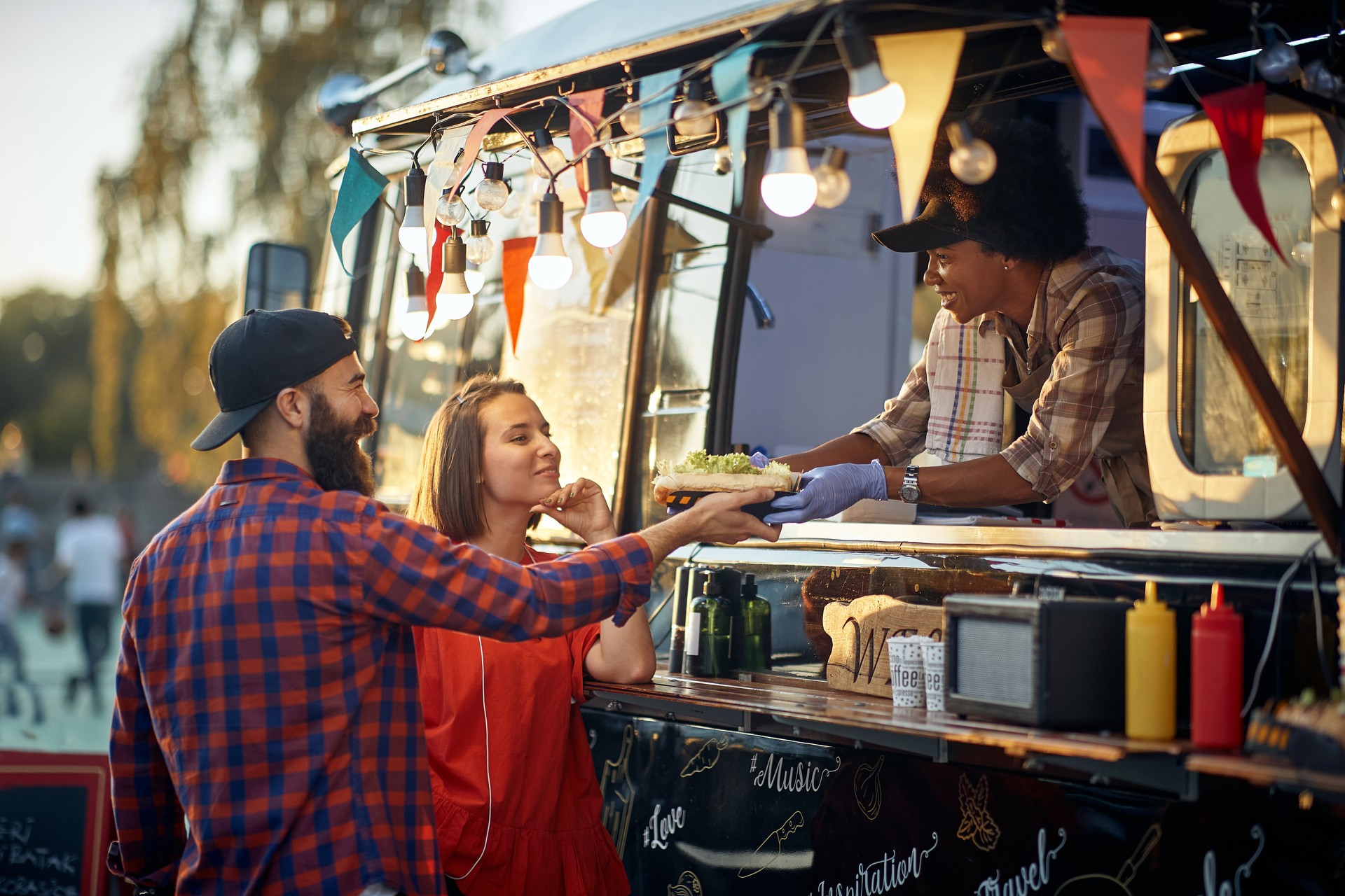 satisfied couple taking ordered sandwiches from an polite and friendly employee